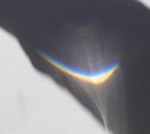 The rainbow in the shadow of L's arm. 